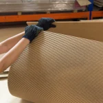 Worker demonstrates flexibility of MDF board in production