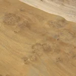 Angled view of the wavy surface of oak burl veneer.