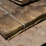 Edge view of American walnut burl veneer bundle showing 0.6 mm thickness