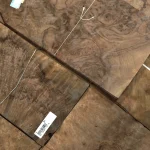 Detailed grain pattern of American walnut burl veneer at an angle