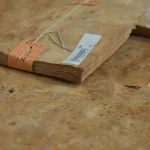 Edge view of 0.6 mm American maple burl veneer pack showing thickness