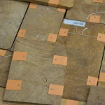 Assorted Myrtle root veneer sheets with tags laid out.