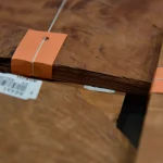 Close-up of Vavona burl veneer bundle edge showing 0.6 mm thickness