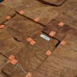 Bundles of Vavona burl veneer laid out for selection in warehouse
