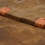 Edge view of Vavona burl veneer bundle showing 0.6 mm sheet thickness