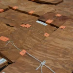 Vavona burl veneer sheets tied with white string and orange clips