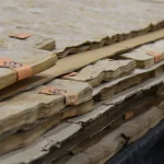 Edges of White Ash burl veneer sheets showing 0.6 mm thickness