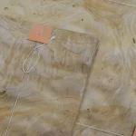 Detail of a White Ash burl veneer sheet with a tag