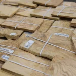Large selection of olive ash burl veneer packs at WoodWay Expert warehouse.