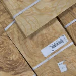 Detailed view of the barcode label on an ash burl veneer pack.