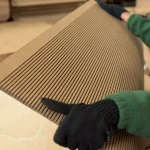 The process of bending a flexible MDF sheet in a workshop