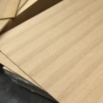 Corner of oak veneered MDF board 17 mm in a stack at the warehouse