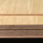 Ends of a stack of veneered MDF boards 9 mm thick, showing the multi-layer structure