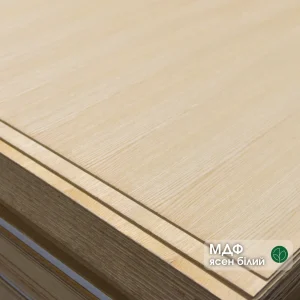 Corner of a 4mm MDF board veneered with white ash in a stack
