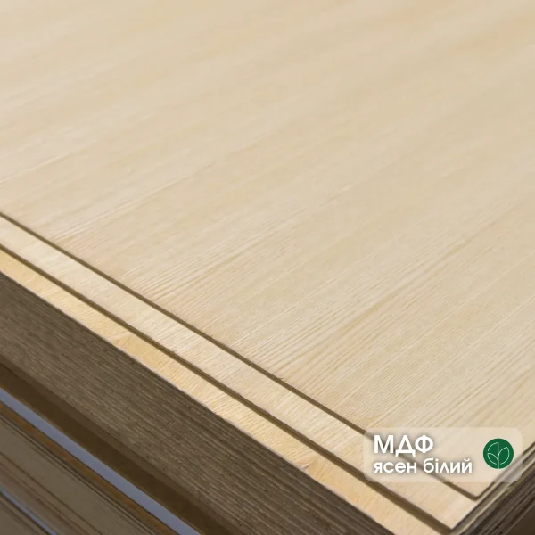 Corner of a 4mm MDF board veneered with white ash in a stack