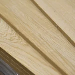 Edges of 17 mm oak veneered MDF boards in a stack