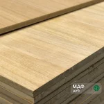 Corner of MDF board faced with sawn oak veneer 19 mm in a stack.