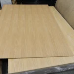 Full sheet of MDF veneered with sawn oak veneer on a pallet.