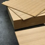 Large stack of oak veneered MDF boards 19 mm in the warehouse.