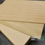 Three oak veneered MDF boards 26 mm stacked fan-wise on the warehouse floor.