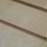 Close-up of the edge of a 9 mm veneered MDF board showing the structure