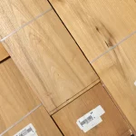 Detailed texture of sawn Acacia wood veneer with barcode labels