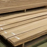 Stacked bundles of sawn elm veneer on a wooden pallet