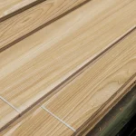 Close-up view of the wood fibers and light tone of sawn elm veneer