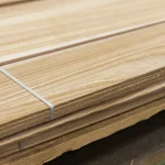 Close-up of strapped sawn elm veneer bundle edges