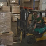 Komatsu forklift moving pallets with sawn veneer at the WoodWay Expert warehouse.