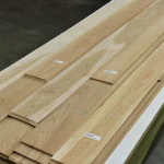 Bundles of sawn cherry veneer 0.5-3 m long on a work table