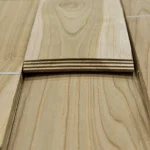 Edges of sawn cherry veneer sheets showing 2.5 mm thickness