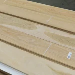 Long sheets of sawn cherry veneer with barcode labels