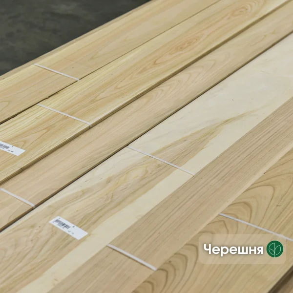 Sawn cherry veneer sheets 4.5 mm thick in bundles in a warehouse