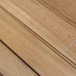 Surface of sawn oak veneer with a distinct wood grain pattern.