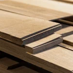 Stack of 2.5 mm thick sawn oak veneer sheets close-up.