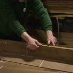 Process of selecting and measuring sawn American Walnut veneer in the warehouse.
