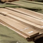Pallets with packs of sawn European Walnut veneer in the warehouse.