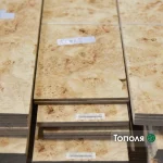 Texture of burl poplar sawn veneer sheets stacked, showing unique eye pattern.
