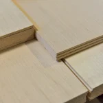 Close-up of the 4.5 mm edge of sawn maple veneer sheets.