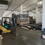 Forklift moving a pallet of sawn veneer in the WoodWay Expert warehouse.