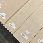 Stacked sawn maple veneer sheets with barcode stickers