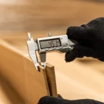 Measuring the thickness of sawn pine veneer with a digital caliper — 4.5 mm.
