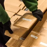 Sorting of sawn pine veneer by a warehouse worker