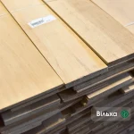 Sawn alder veneer sheets 4.5 mm thick stacked in packs at the warehouse.