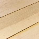 Close-up texture and grain pattern of natural sawn alder veneer.