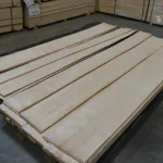 Bundles of natural sliced European birch veneer 2-3.8 m long on a warehouse pallet
