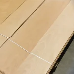 Warehouse pallet with packs of sliced beech veneer 0.6 mm tied with straps.