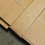 Top view of stacked sheets of extra grade natural sliced beech veneer.