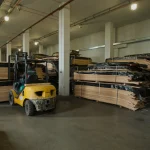 Forklift in the WoodWay Expert veneer and lumber warehouse near racks.